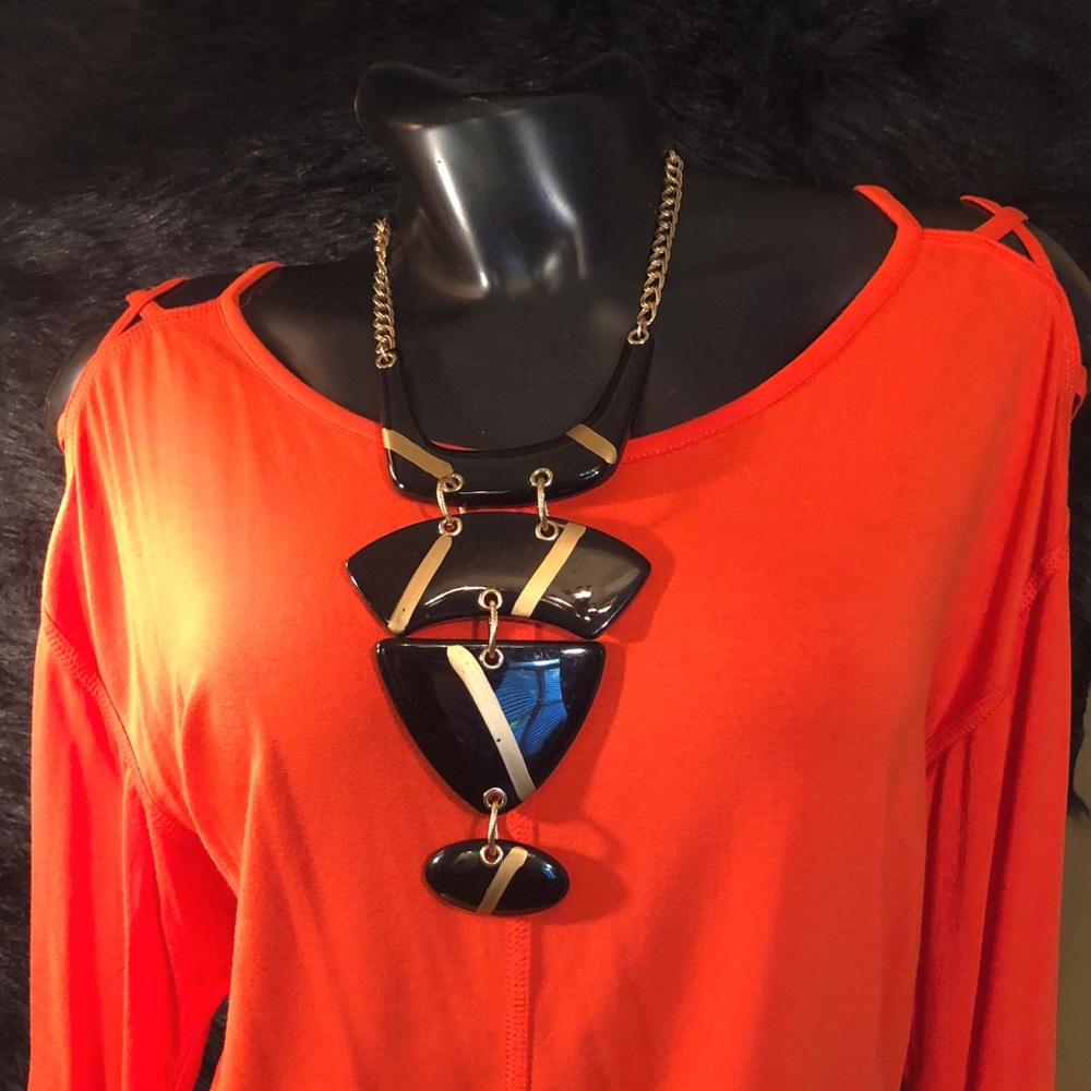 Chico’s Orange top; openings on shoulder; size 2